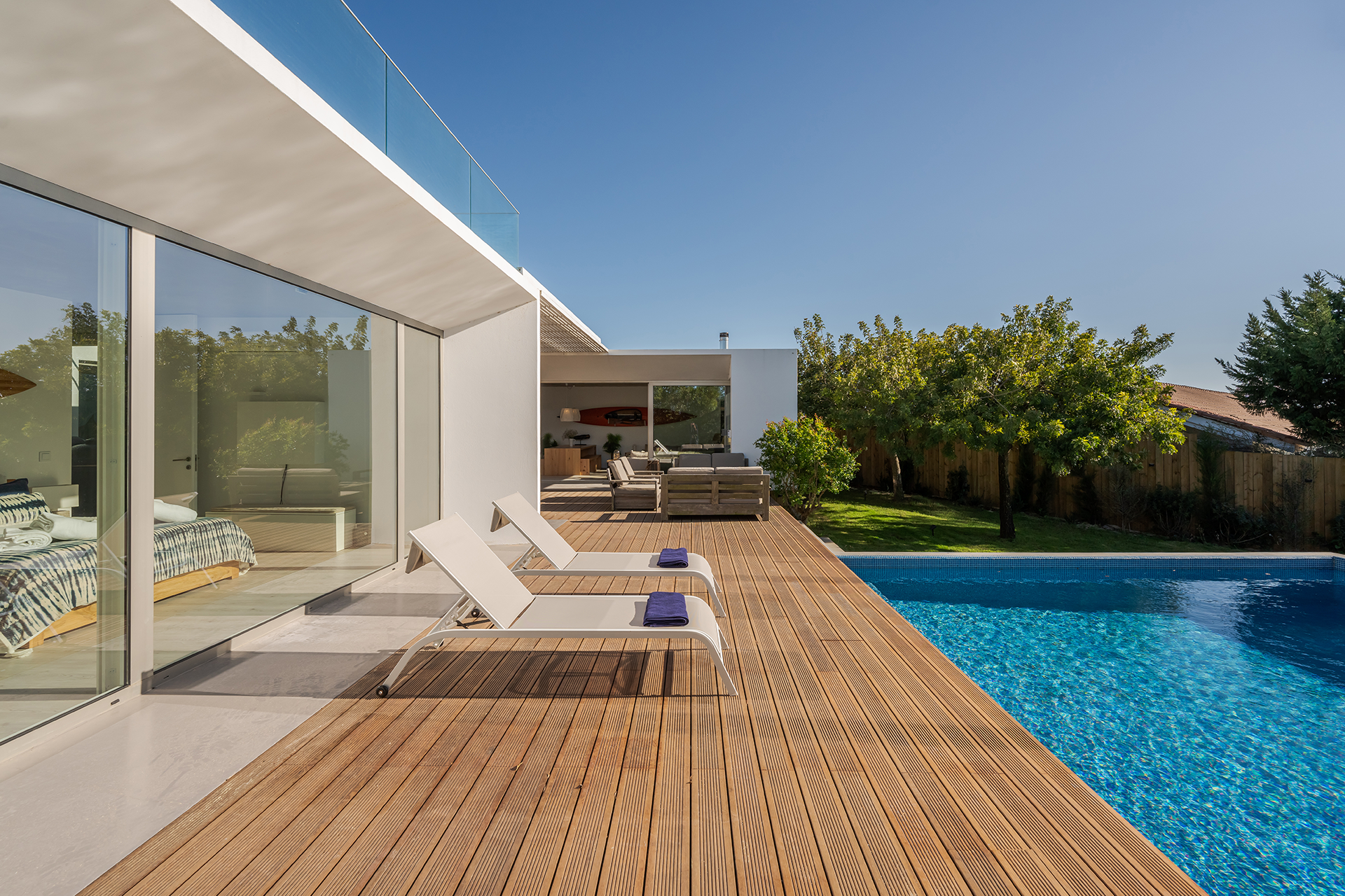 Backyard wood deck with stairs and modern railing