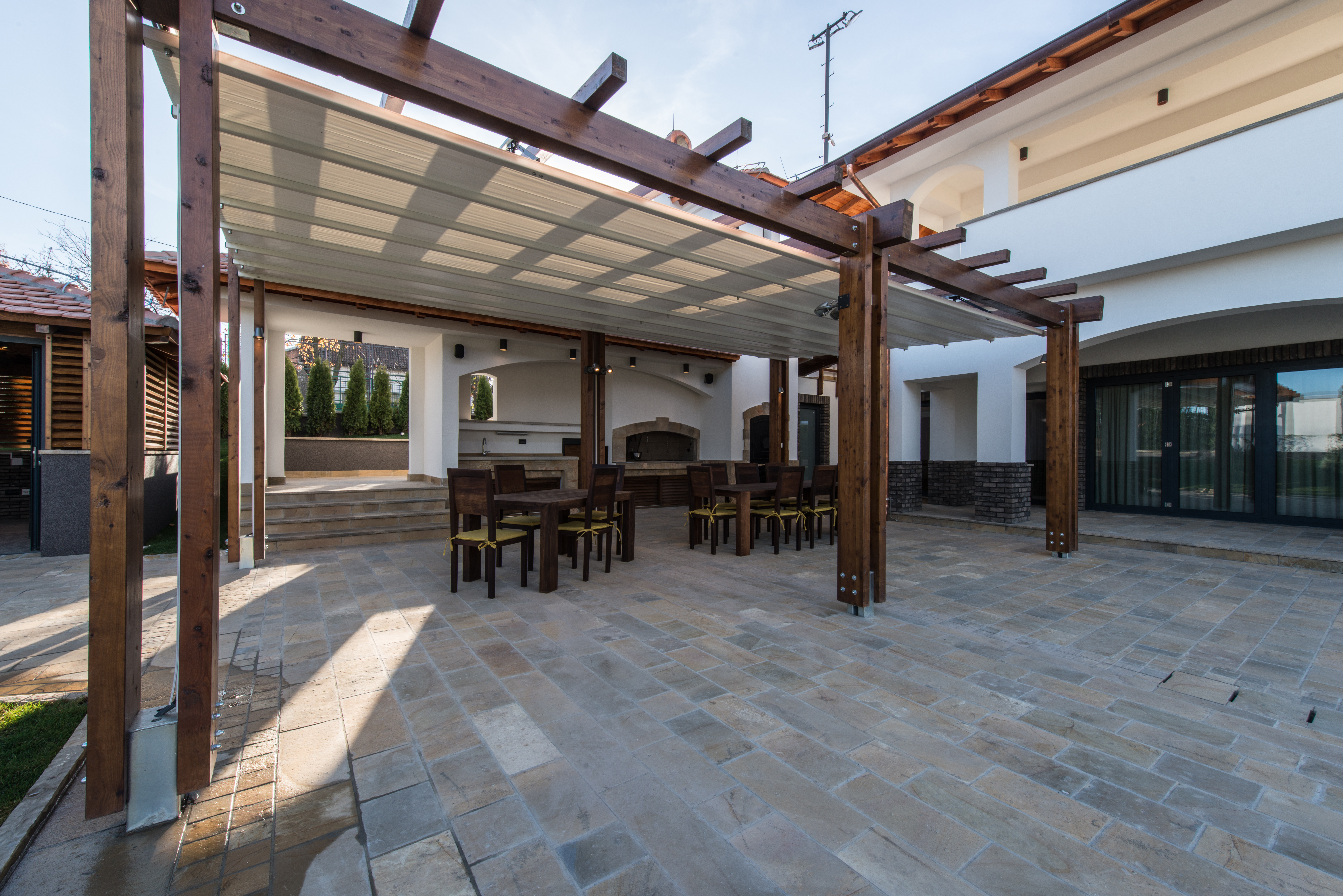 Aluminum or vinyl patio cover attached to the home with clean fascia and shade